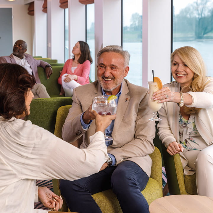 Guests enjoying drinks in the Belvedere Lounge Bar aboard Spirit of the Danube